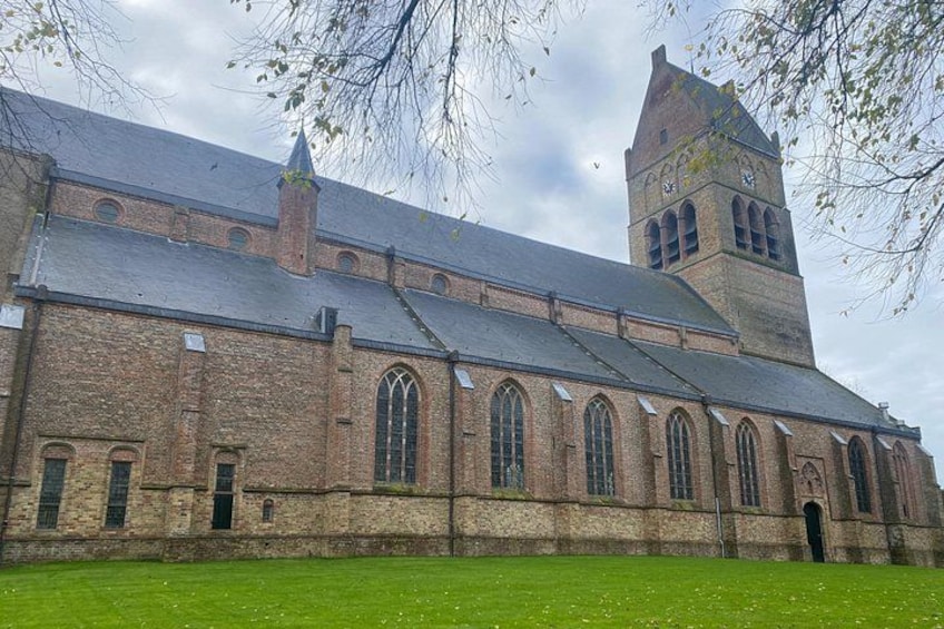 A large brick church with a tall tower and arched windows. 5