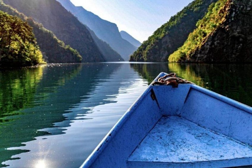 A boat on calm water with mountains in the background. 3
