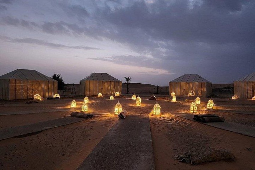 Yurts with lanterns in a desert setting. 2