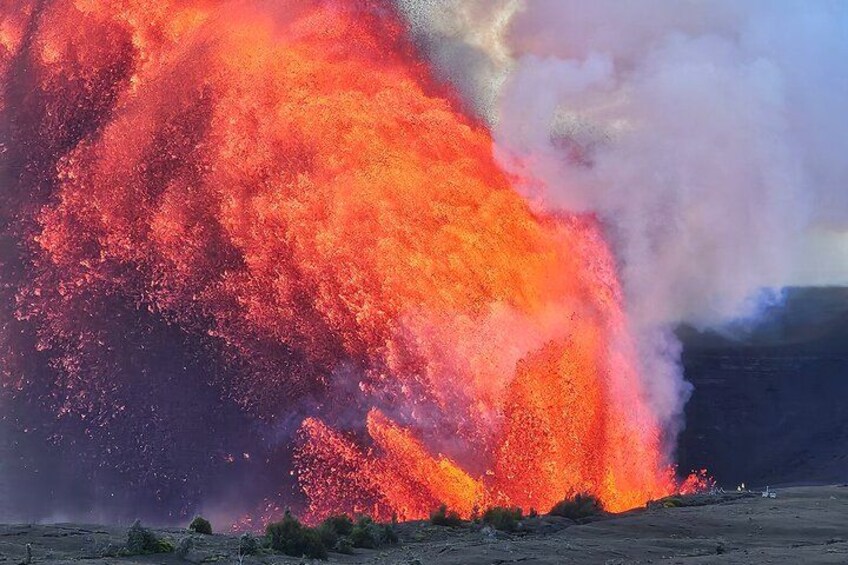 Una erupción volcánica con lava fluyendo y nubes de ceniza elevándose. 2