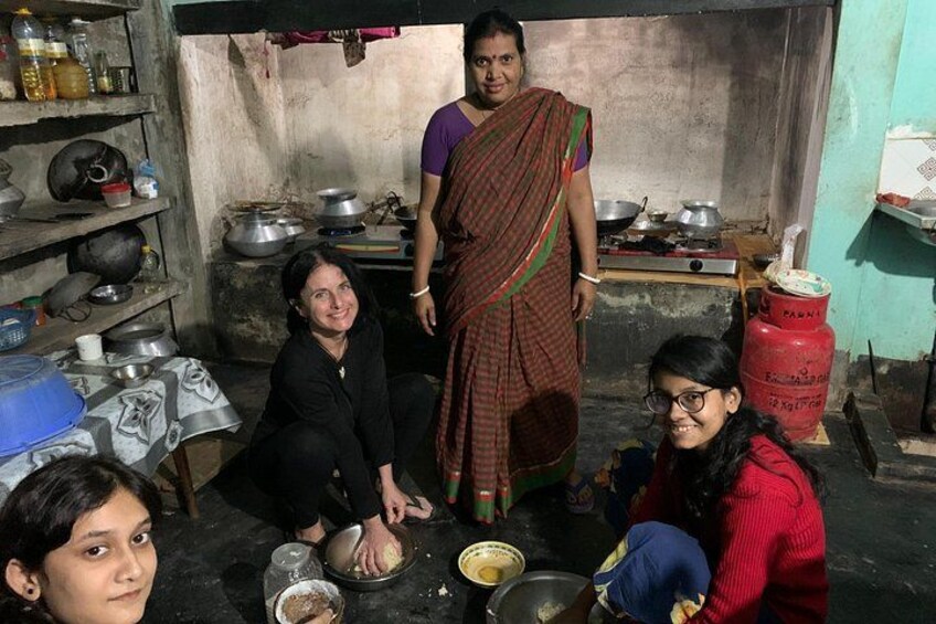 A kitchen with cooking utensils, a gas cylinder, and a person standing. 2