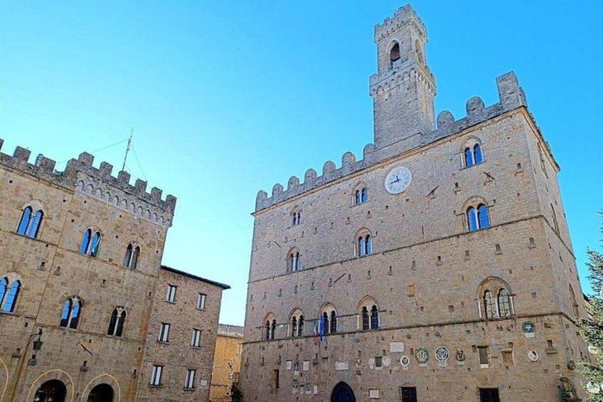 A historic building with a clock tower and arched windows. 2