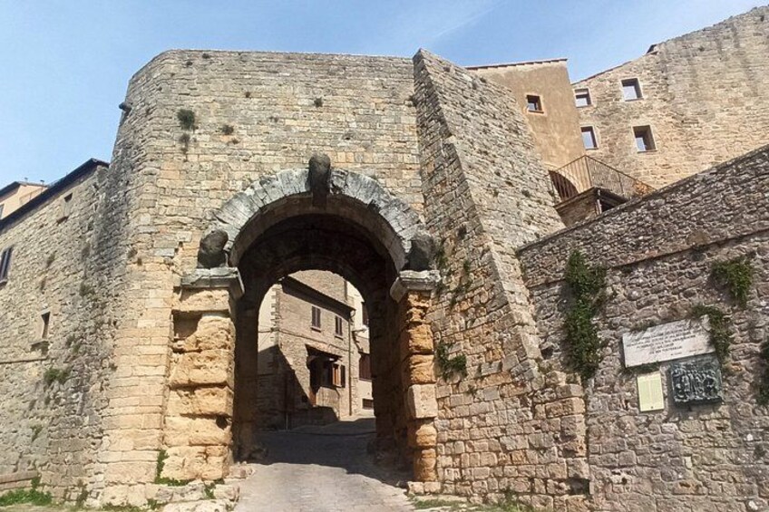 An ancient stone archway leading into a historic building. 4