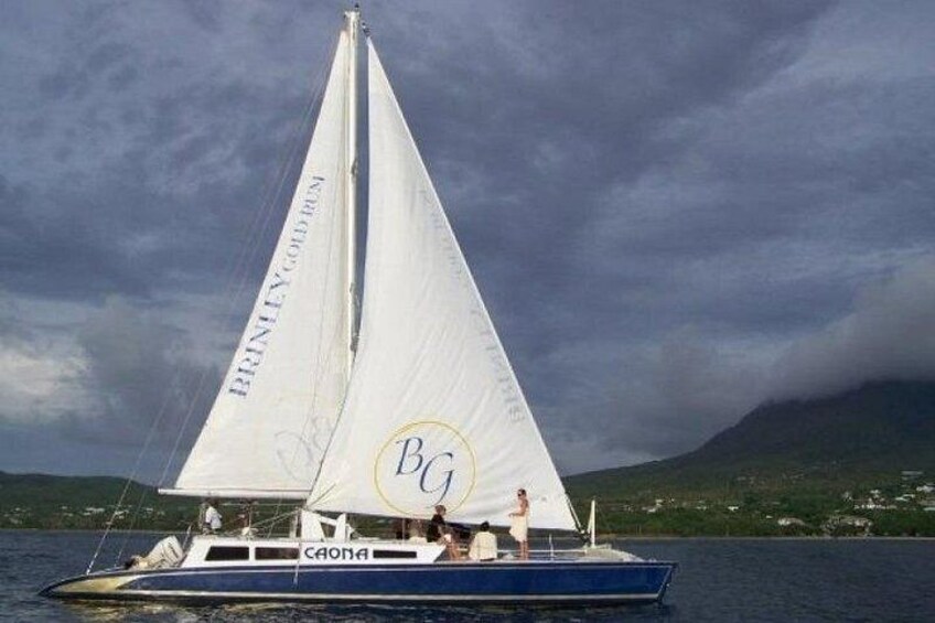 A sailboat with a white sail, the name 'BENNY GOLDEN' on the sail, and the logo 'BG' on the sail's center. 5