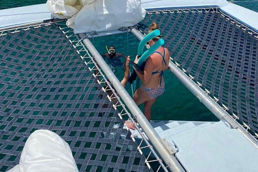 A person in a swimsuit on a boat deck with a pool. 3