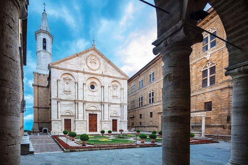 A historic building with a bell tower, a courtyard with a fountain, and classical architecture. 4