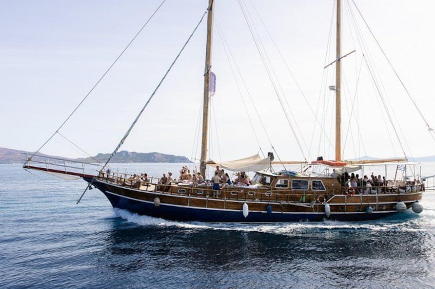 A wooden boat with multiple masts sailing on calm waters. 5