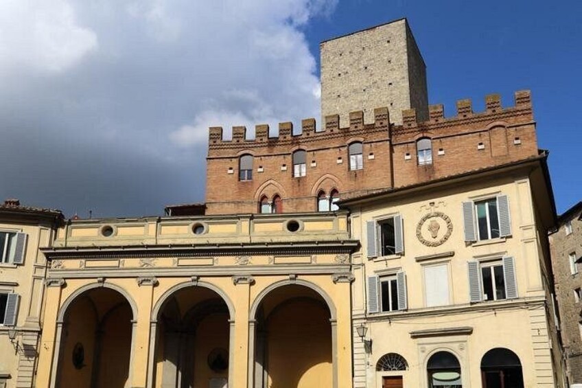 A historic building with a prominent tower and arched entrance. 4