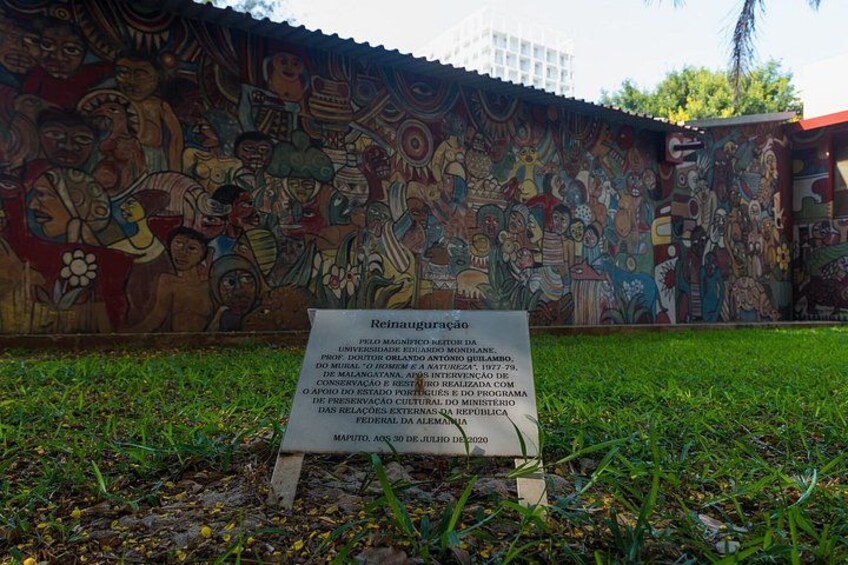 Un mural con un letrero frente a él. 5