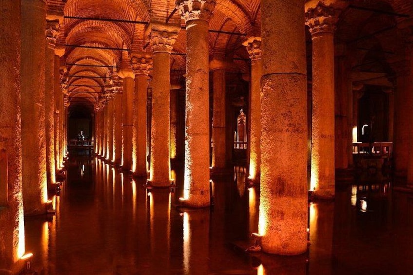 A corridor with columns and arches, illuminated by warm lighting. 4