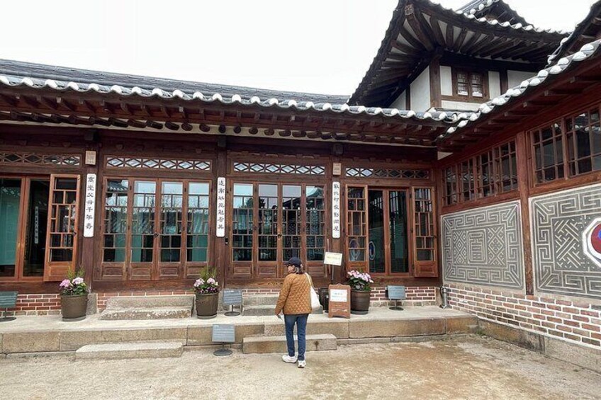 A traditional wooden building with large windows and a tiled roof. 2