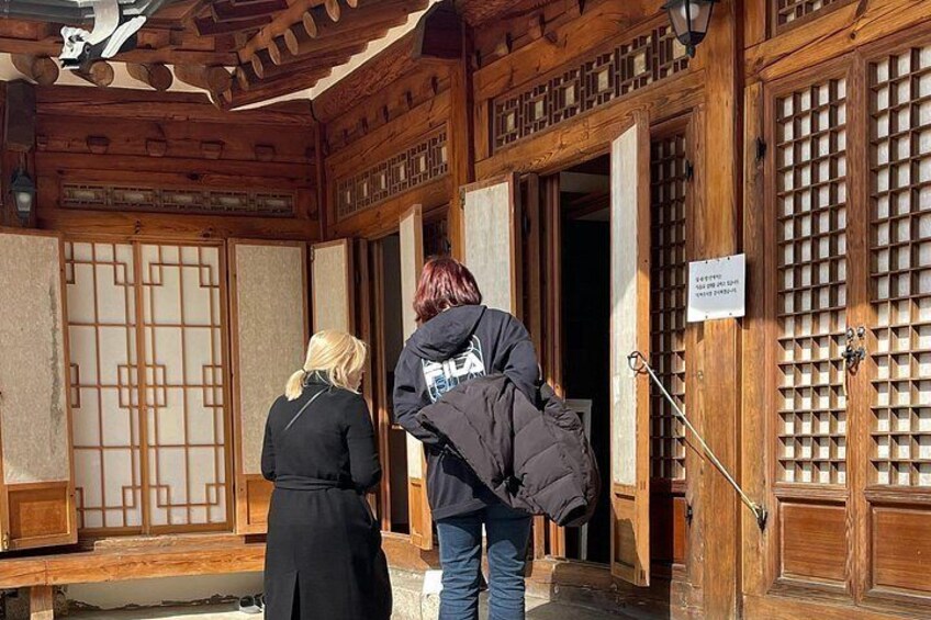 A traditional wooden building with a sliding door and a sign. 3