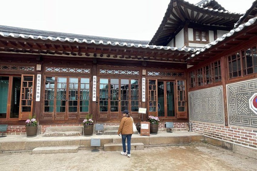 A traditional wooden building with large windows and a tiled roof. 2