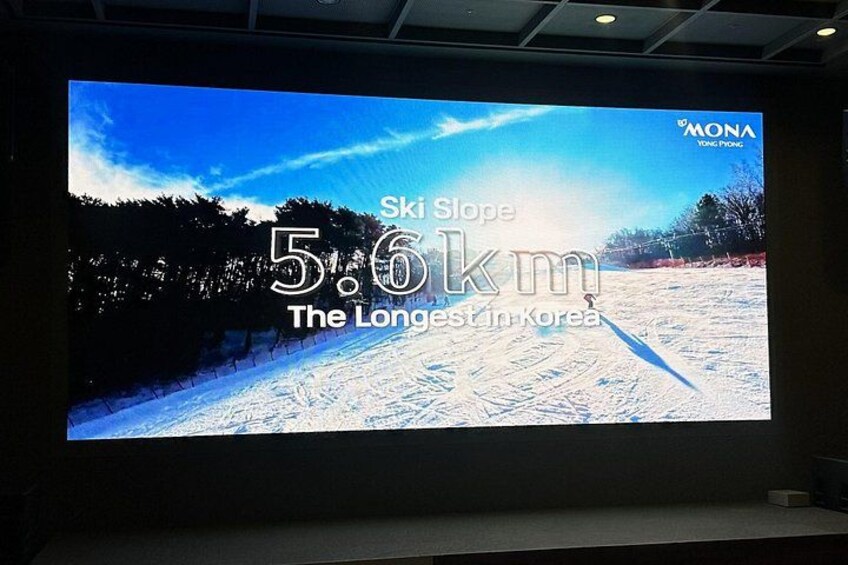 A large screen displaying a ski slope with a distance of 5.6 km. 5