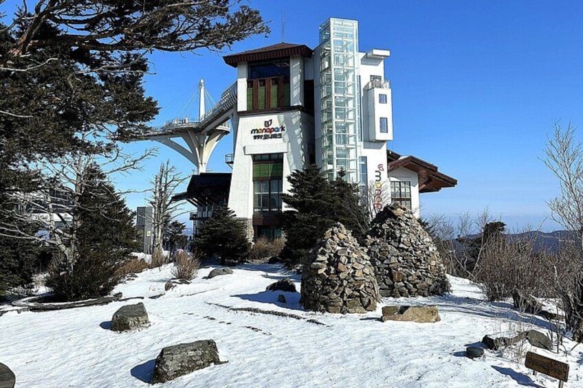 A snow-covered building with a ski lift in the background. 2