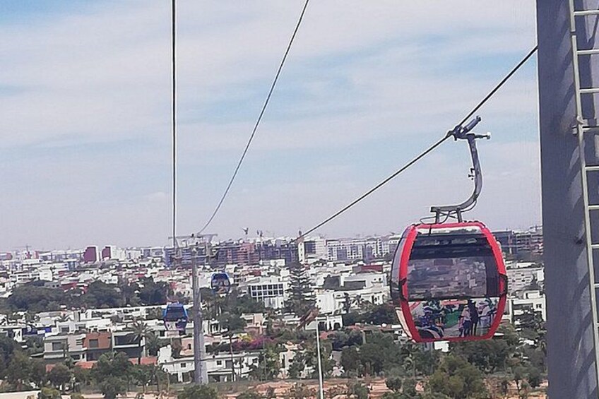 A cable car in a cityscape with buildings and a clear sky. 3