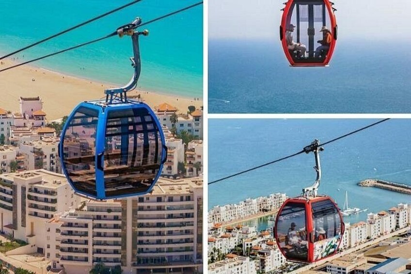 A cable car system with a blue and red gondola, a beach, and a coastal cityscape. 2