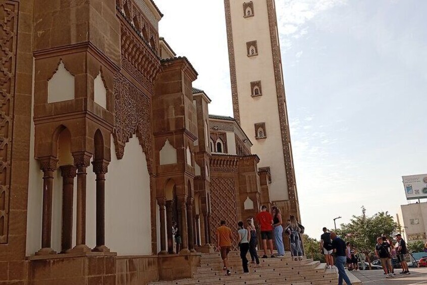 A historic building with intricate arches and a tall minaret. 2