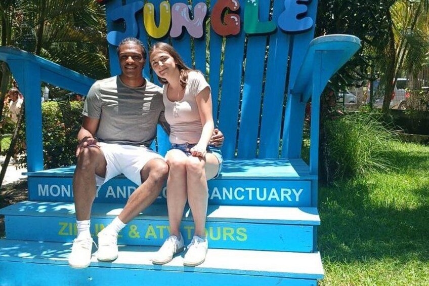 A couple sitting on a blue chair with the words 'Jungle' and 'Montezuma's Sanctuary' visible. 4