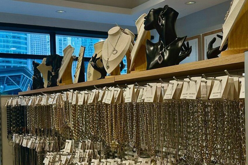 A jewelry store with various necklaces and a mannequin display. 4