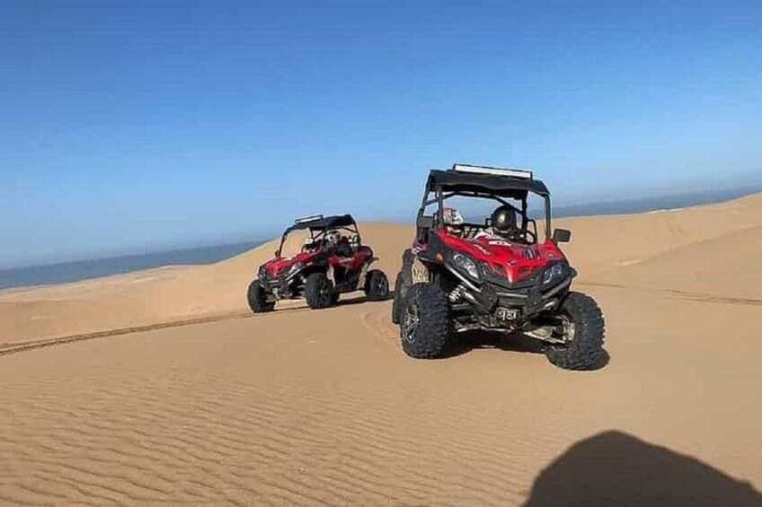 Two off-road vehicles on a sandy dune landscape. 4
