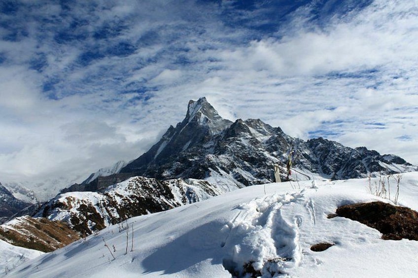 A snow-covered mountain peak with a clear sky. 1