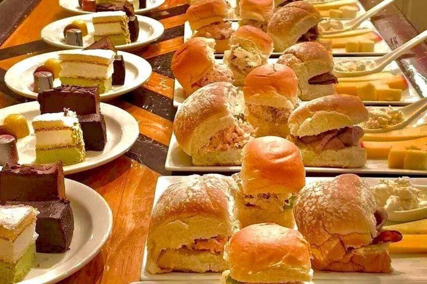 Indulge in Flavor: A delightful lunch plate featuring three scrumptious sliders including, a savory roast beef slider, chicken and salmon sliders, Then! A sweet finish with dessert and tasty truffles! 1