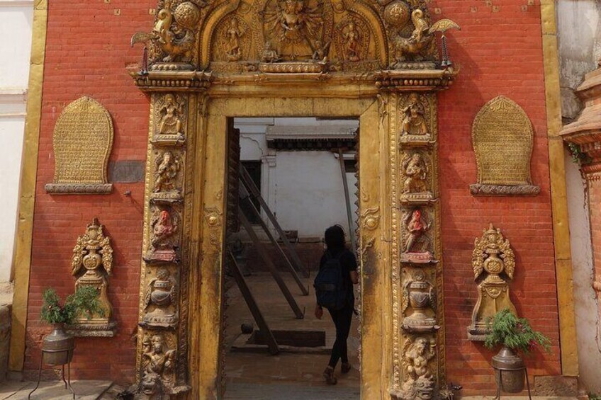 A red brick building with a golden ornate entrance. 2