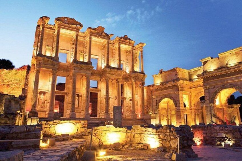 Ancient ruins with columns and arches, illuminated by artificial lighting. 3
