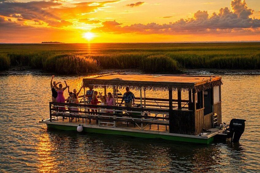 A boat with people on a body of water during sunset. 2