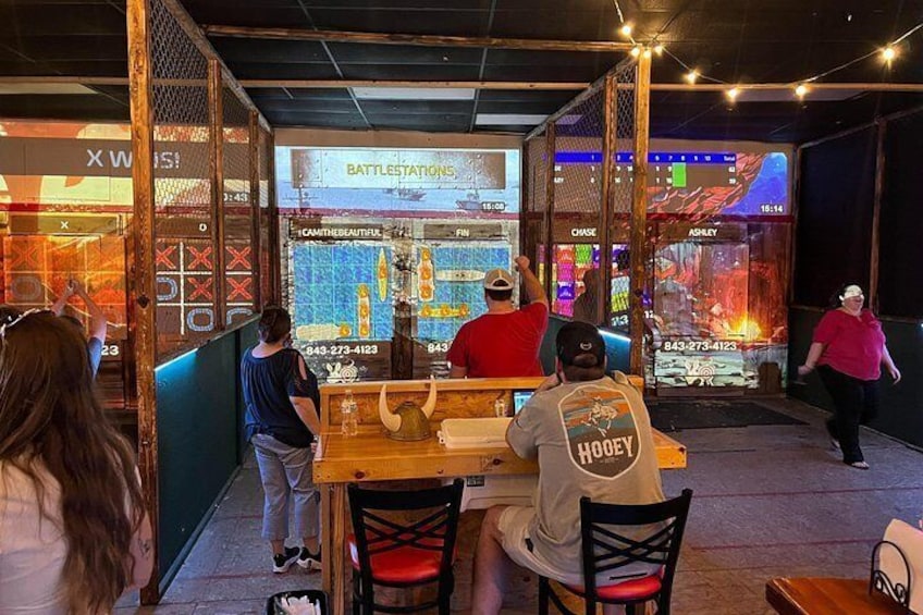 A gaming arcade with neon lights and a 'Battlestations' sign. 3