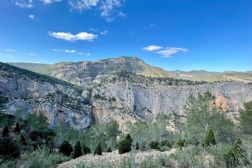 A mountainous landscape with rocky terrain and sparse vegetation. 1