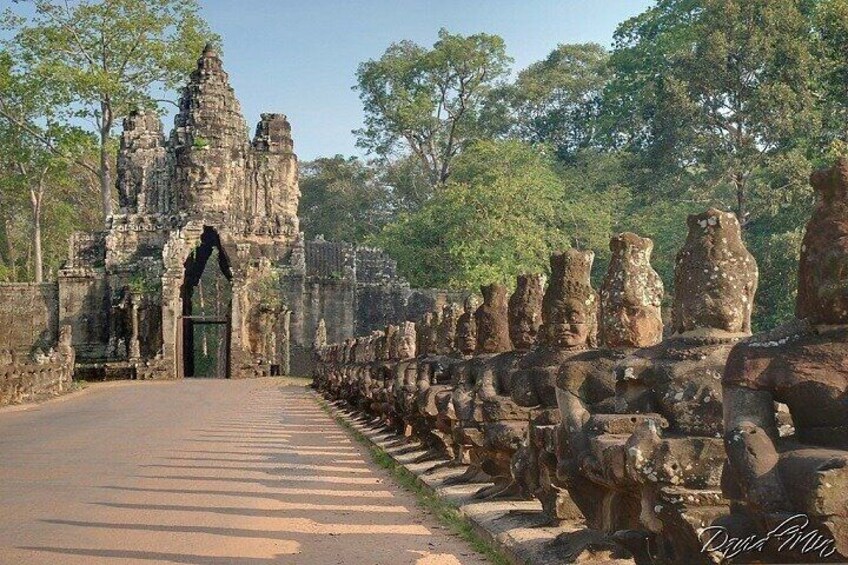 A temple entrance with a stone pathway leading to a large, ornate structure. 4