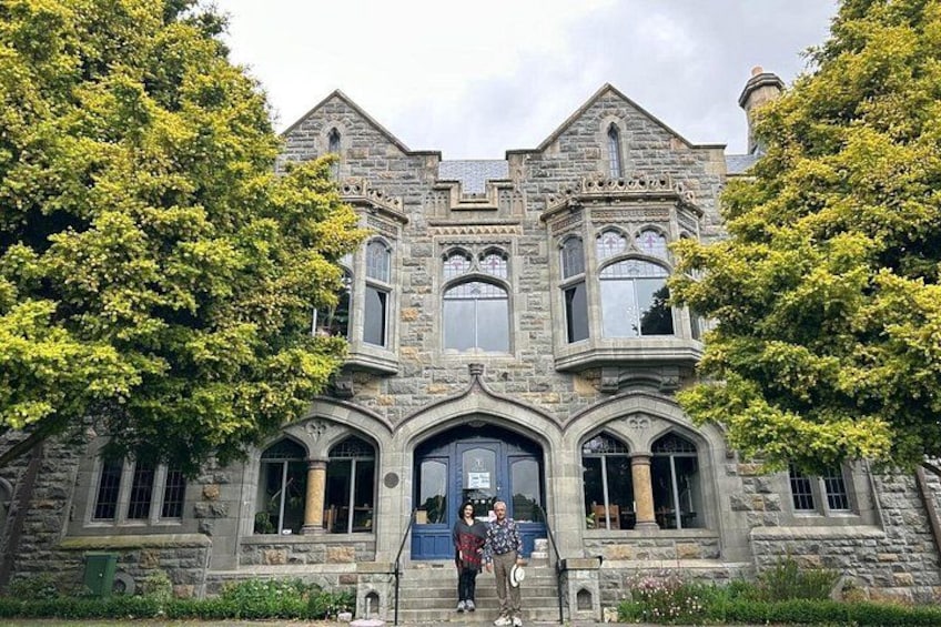 A large stone building with arched windows and a prominent entrance. 1