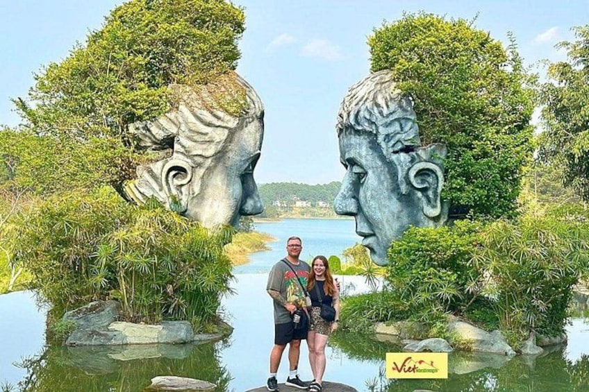 A sculpture of a man's face with a river in the background. 3