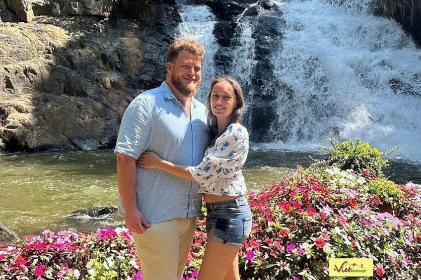 A waterfall, a couple, and colorful flowers. 2