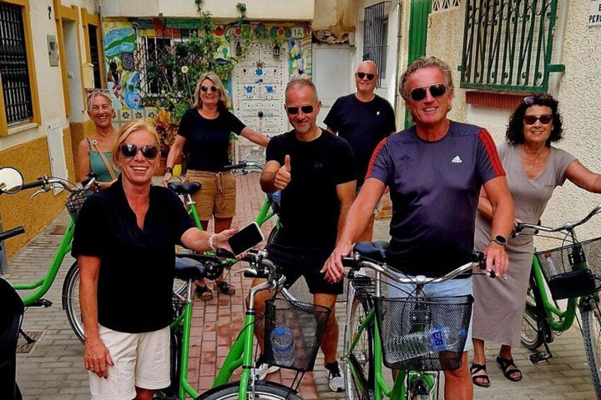 A group of people with bicycles in an urban setting. 2