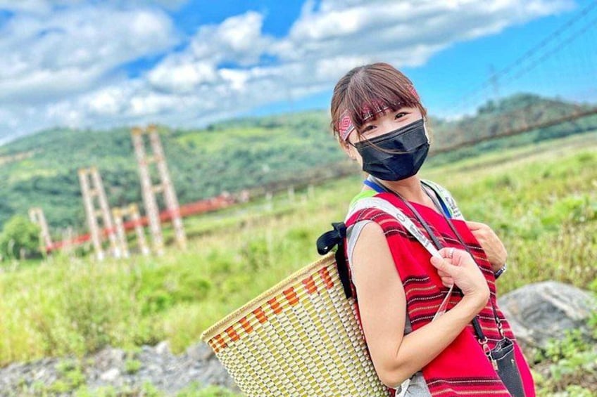 A person with a backpack standing in a rural landscape with hills and a clear sky. 2