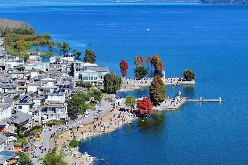 A coastal town with a marina, waterfront promenade, and residential buildings. 4