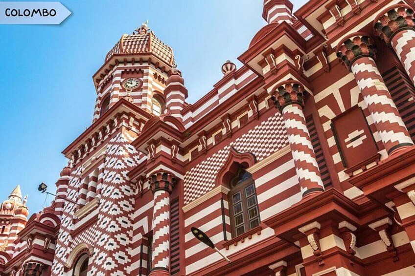 A red and white striped building with domed towers and intricate architectural details. 4
