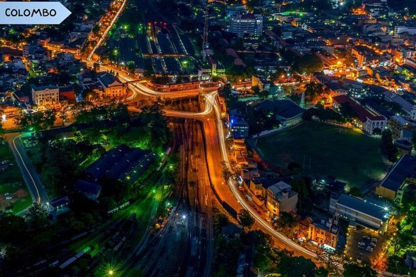 An aerial view of Colombo at night with illuminated roads and buildings. 5
