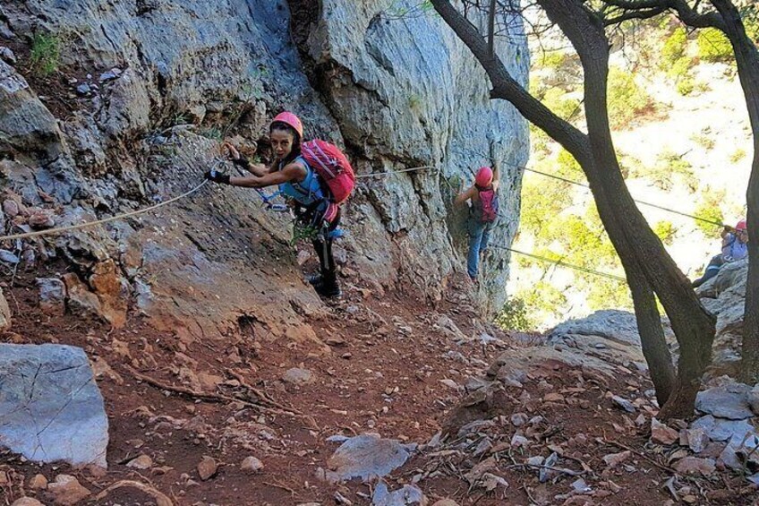 Two people rock climbing on a rocky cliff. 2