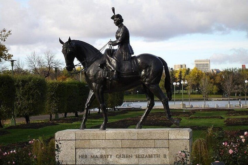 A statue of a person on horseback with a plaque that reads 'Her Majesty Queen Elizabeth II.' 4