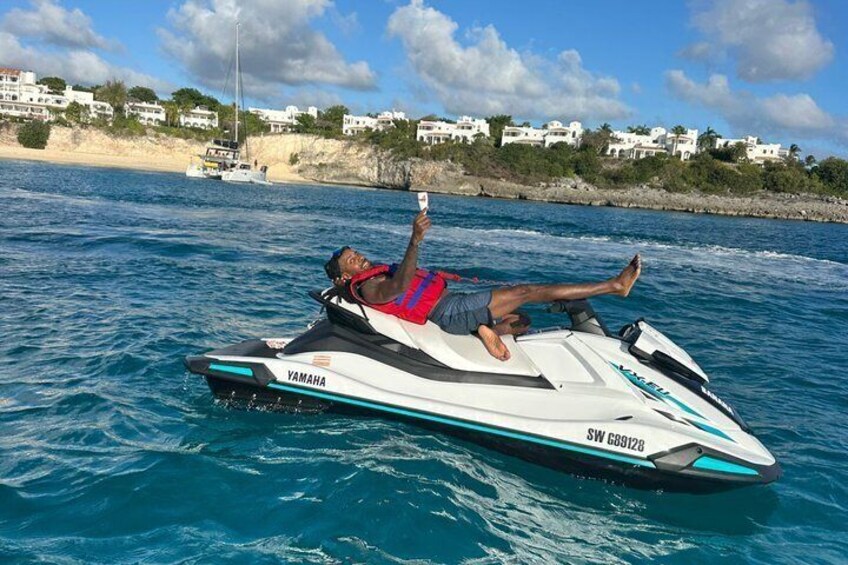 A person on a Yamaha jet ski with a coastal landscape in the background. 5