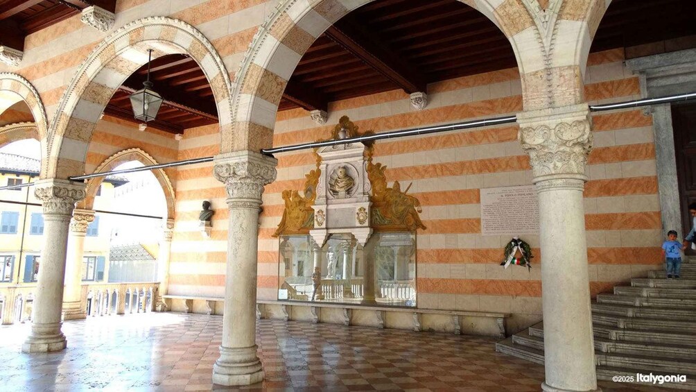 An architectural interior with arches, columns, and a central decorative element. 2