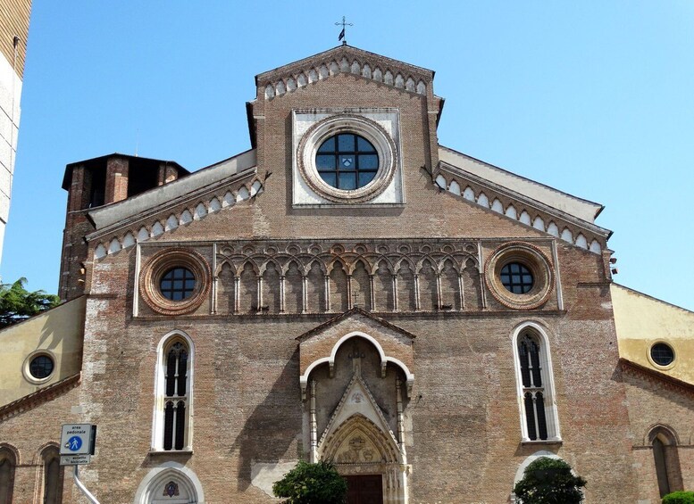 A historic church with a central circular window, arched windows, and a pointed arch entrance. 5