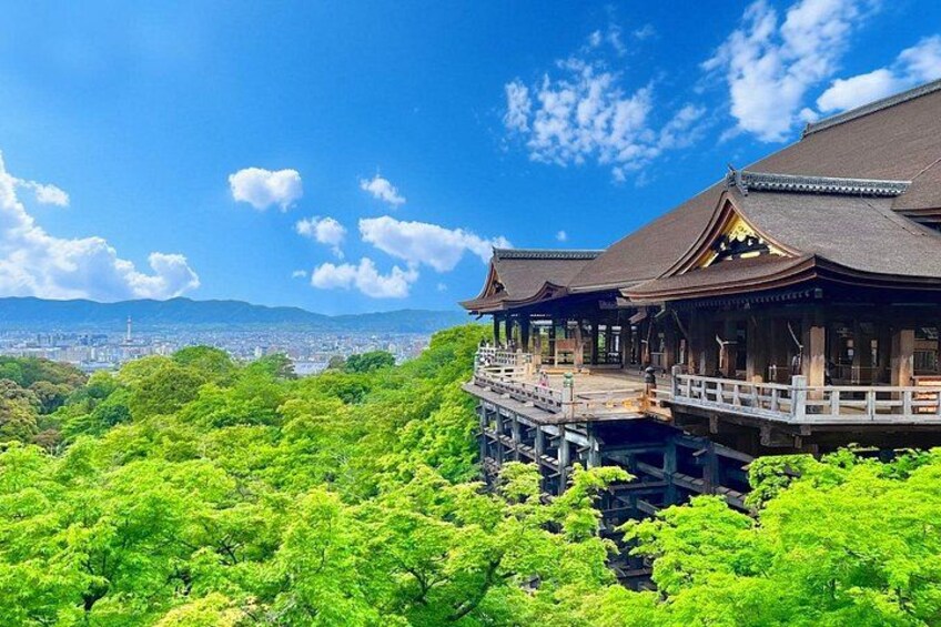 A traditional Japanese building with a view of a cityscape and lush greenery. 3