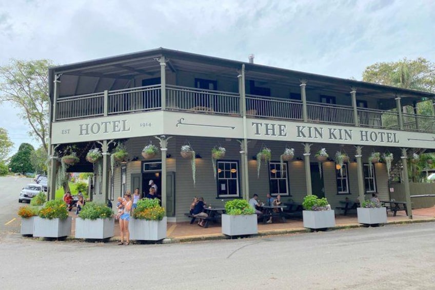 The Kin Kin Hotel with outdoor seating and hanging plants. 4