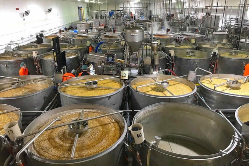 Industrial processing equipment with large metal vats and machinery. 5