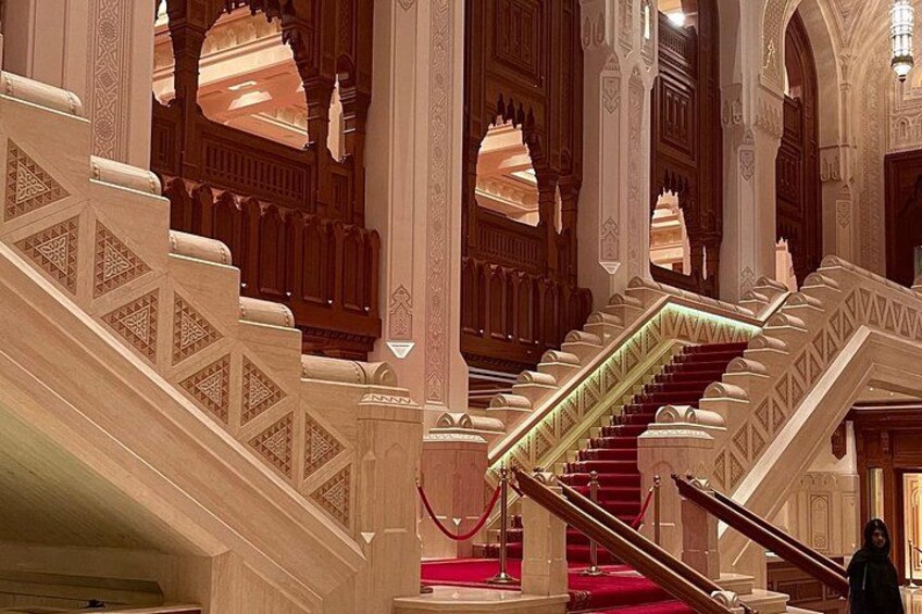 A grand staircase with ornate railings and red carpet. 5